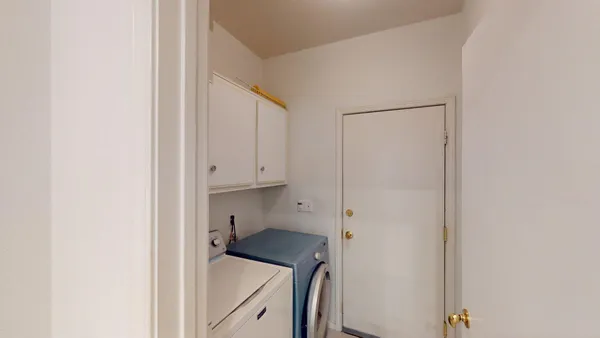 a view of walk in closet with white walls