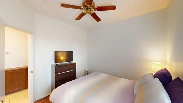 a bedroom with a bed and a television