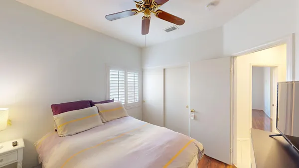 a bedroom with a bed and a chandelier