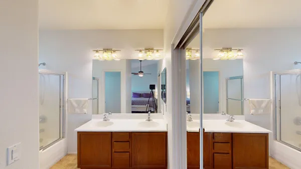 a bathroom with a double vanity sink and mirror