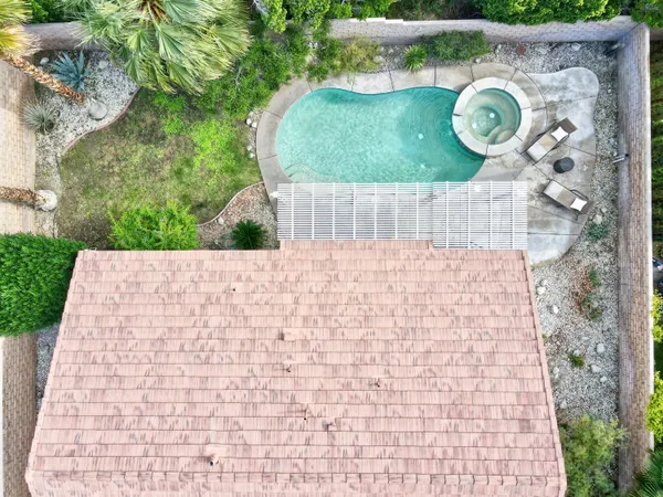 an aerial view of residential house with outdoor space and swimming pool