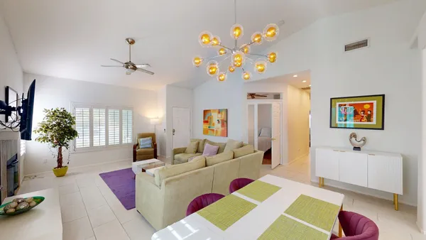 a living room with furniture and a chandelier