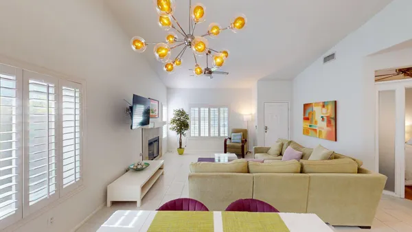 a living room with fireplace furniture and a flat screen tv