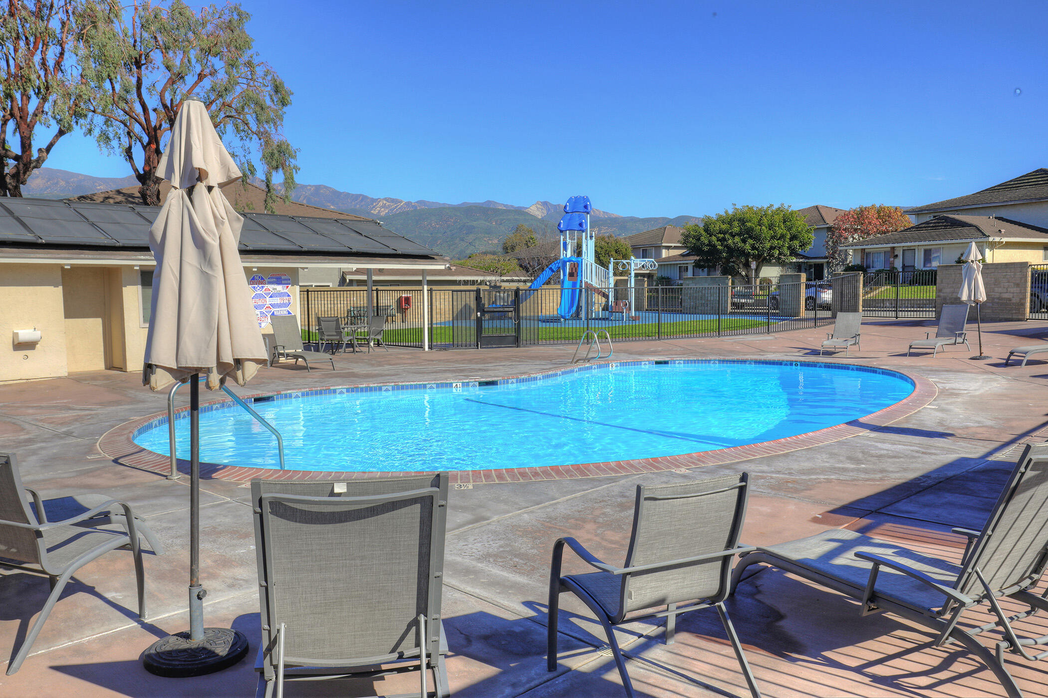 5945 Hickory Street, Unit 4 Carpinteria, CA 93013 - Photo 17 of 19 a view of a swimming pool with a lounge chairs