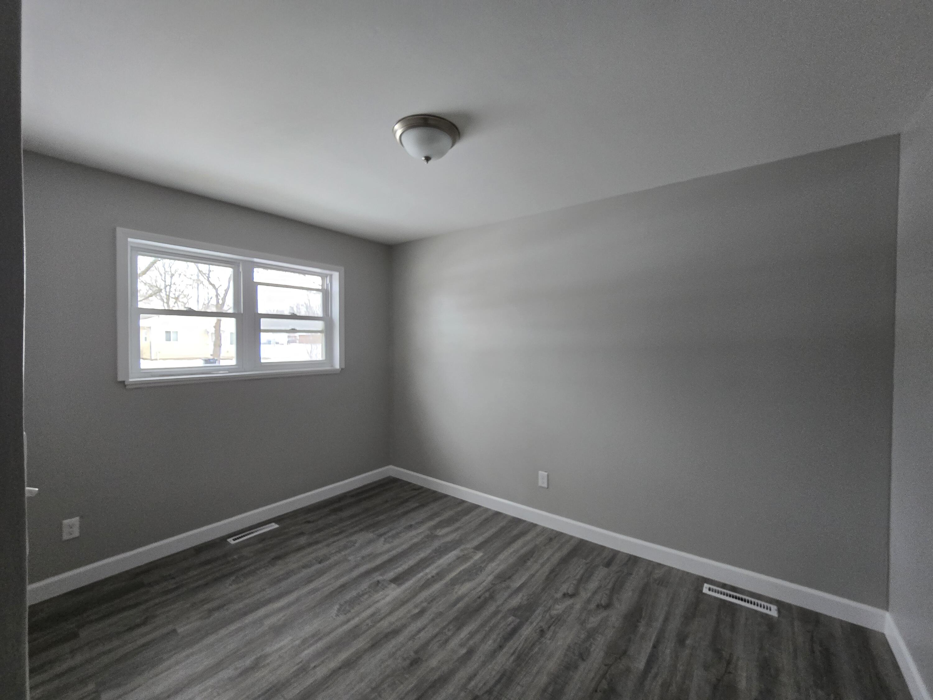 1044 Hobart Street Gary, IN 46406 - Photo 16 of 22 wooden floor in an empty room with a window