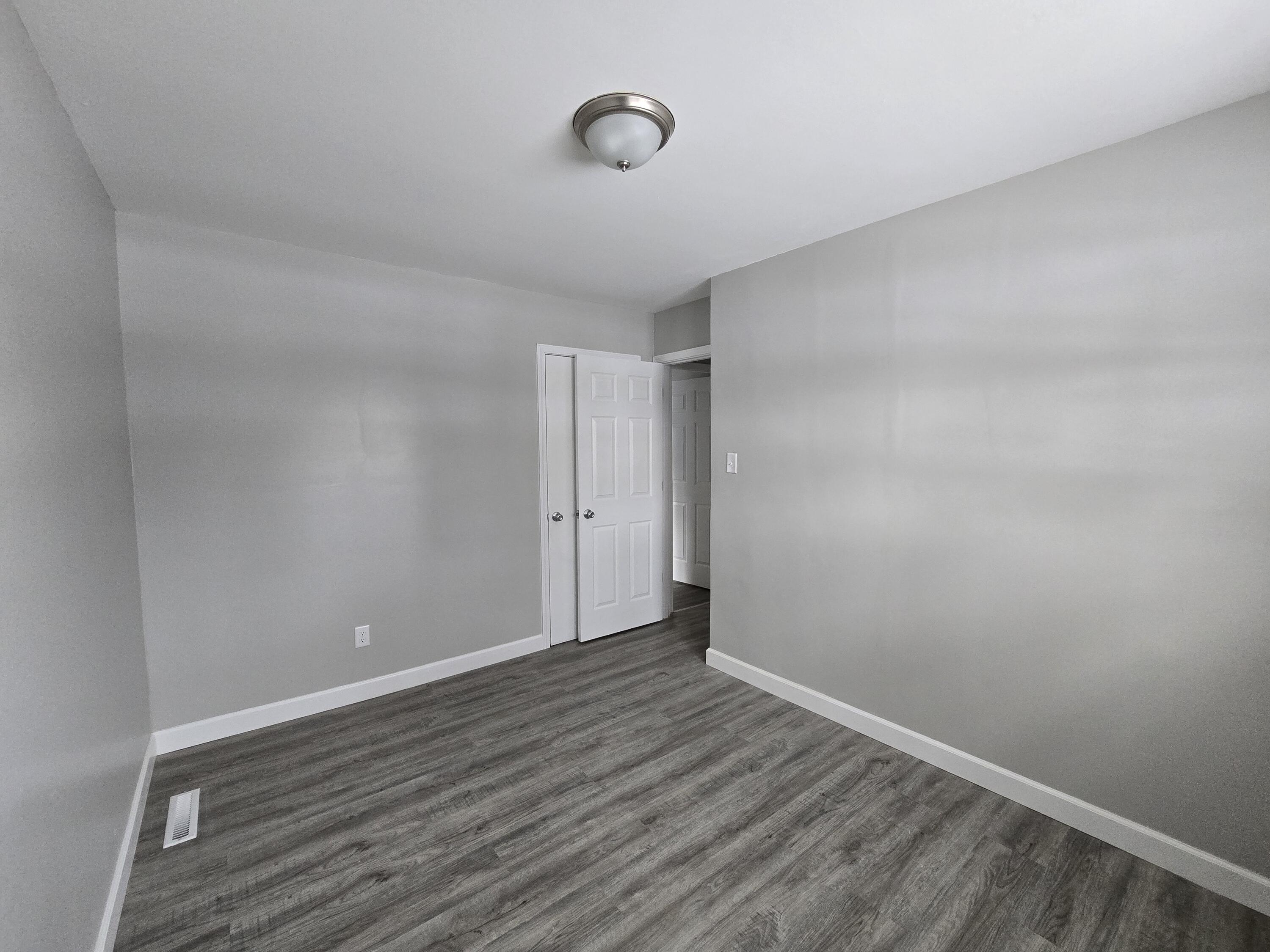1044 Hobart Street Gary, IN 46406 - Photo 17 of 22 a view of an empty room with wooden floor