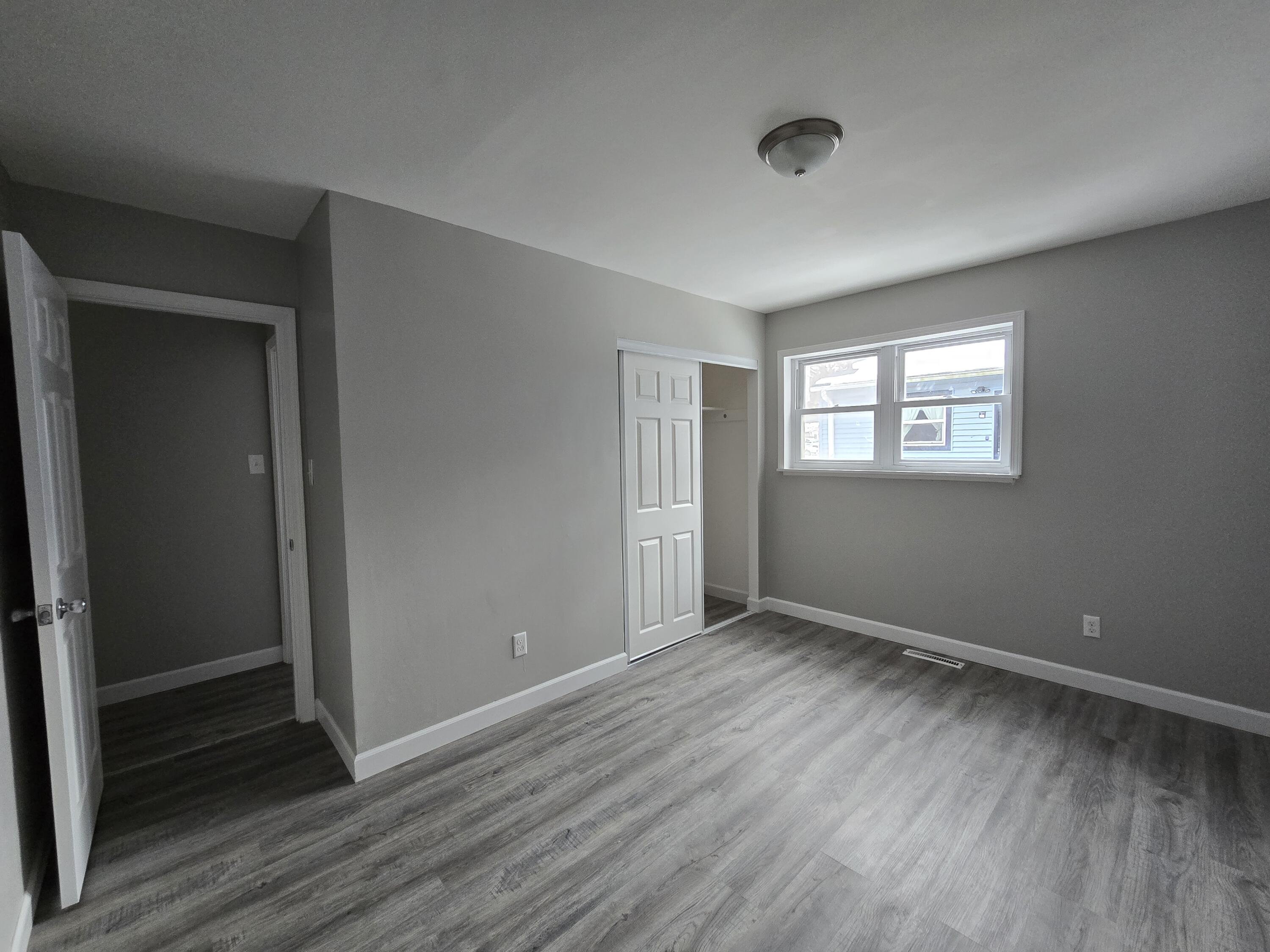 1044 Hobart Street Gary, IN 46406 - Photo 19 of 22 an empty room with wooden floor and windows