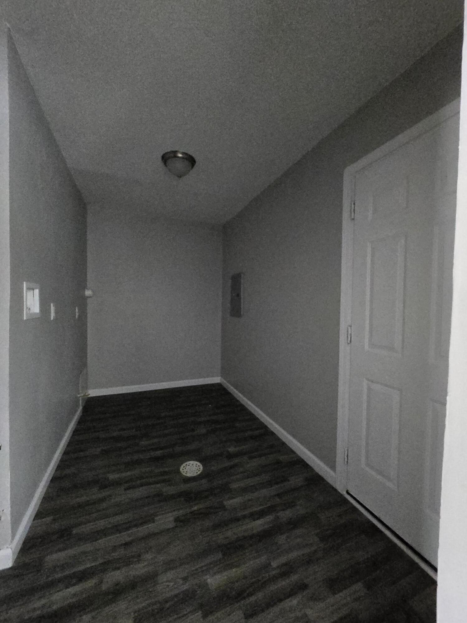 1044 Hobart Street Gary, IN 46406 - Photo 21 of 22 a view of an empty room with wooden floor and a window