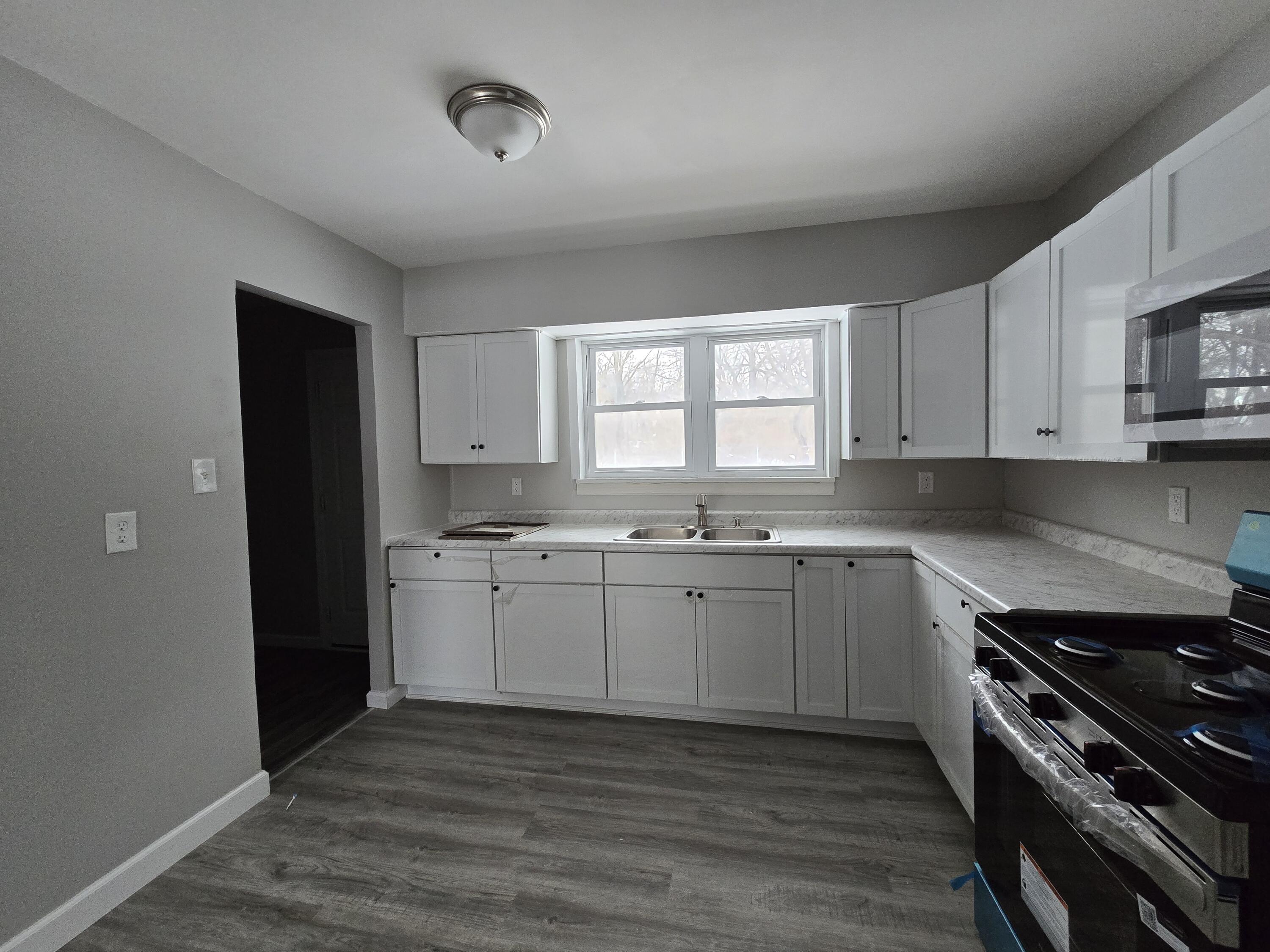 1044 Hobart Street Gary, IN 46406 - Photo 8 of 22 a kitchen with granite countertop cabinets stainless steel appliances and a window
