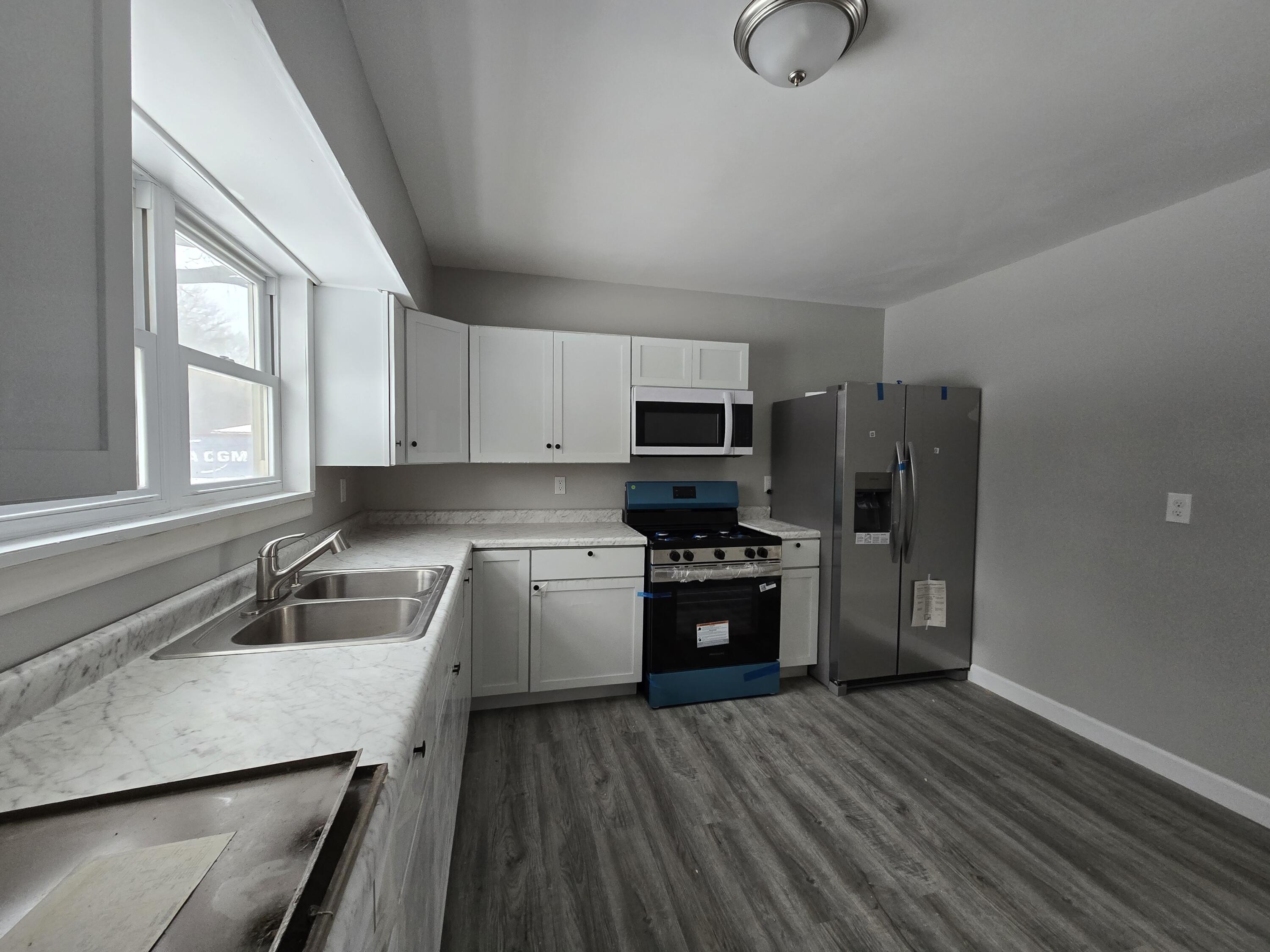 1044 Hobart Street Gary, IN 46406 - Photo 9 of 22 a kitchen with stainless steel appliances granite countertop a sink dishwasher stove and refrigerator