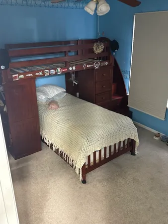 a bedroom with a bed and a mirror