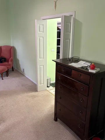 a room with a dresser and a window