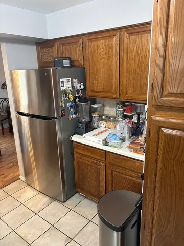 a kitchen with a refrigerator a sink and cabinets