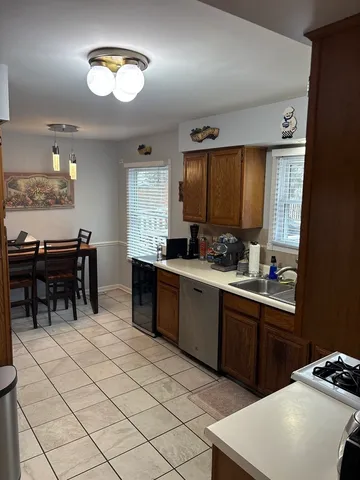a kitchen with sink cabinets and appliances