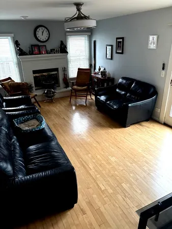 a living room with furniture a fireplace and a window