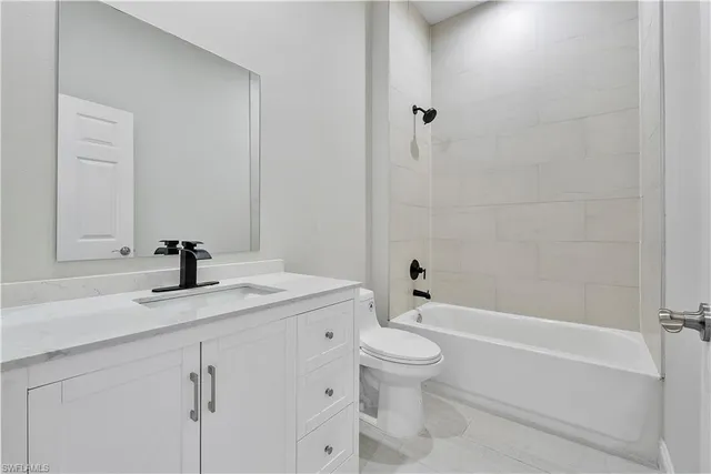 a bathroom with a bathtub toilet sink and mirror