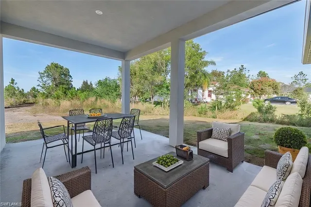 a view of a patio with couches potted plants and a table