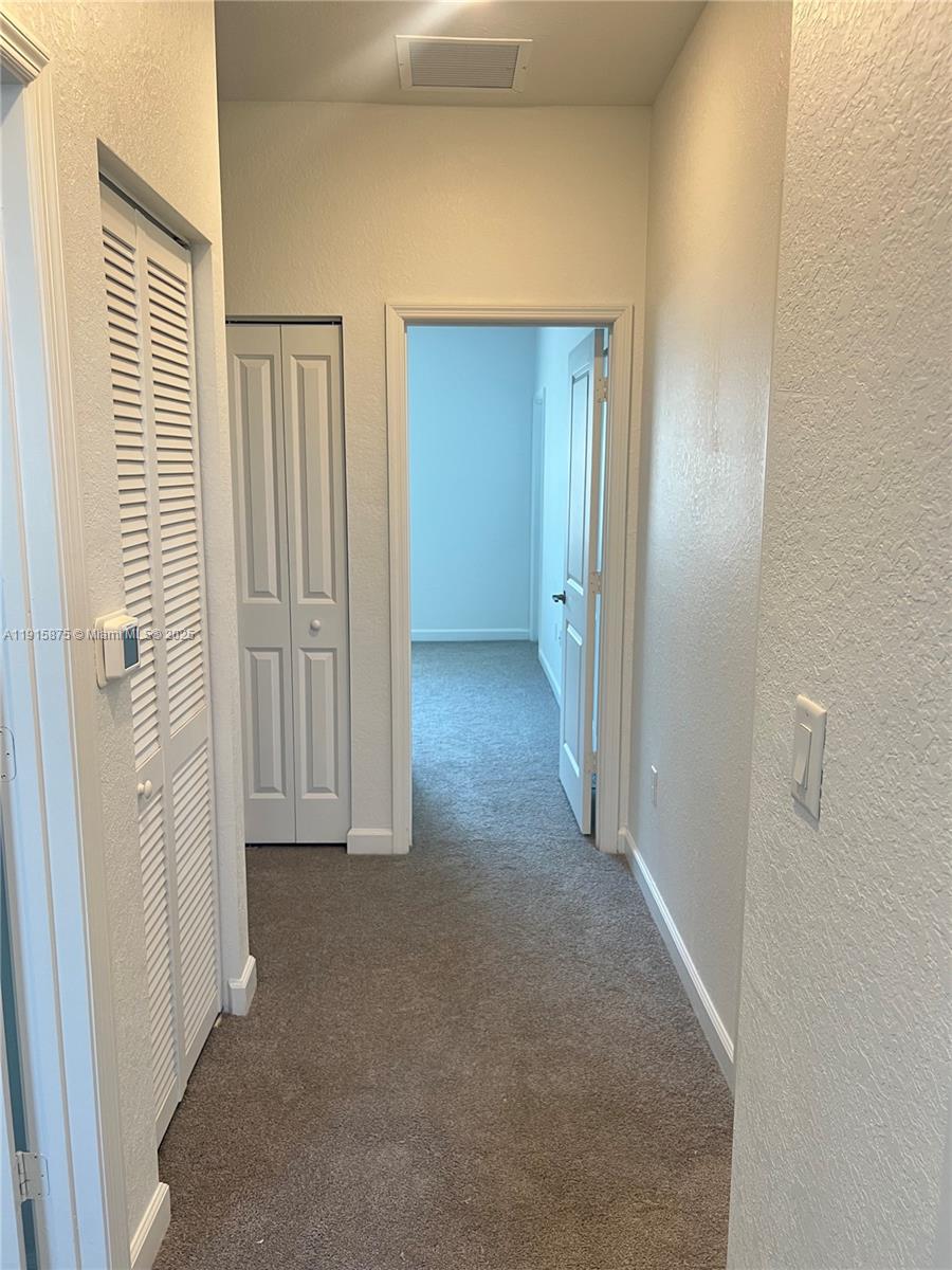 28701 Southwest 132nd Place Homestead, FL 33033 - Photo 15 of 17 an empty room with windows