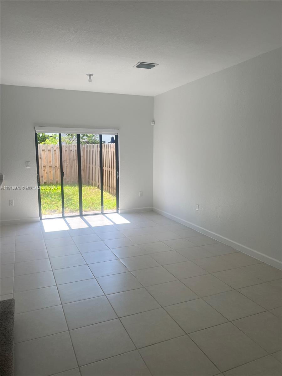 28701 Southwest 132nd Place Homestead, FL 33033 - Photo 4 of 17 a view of an empty room with a window