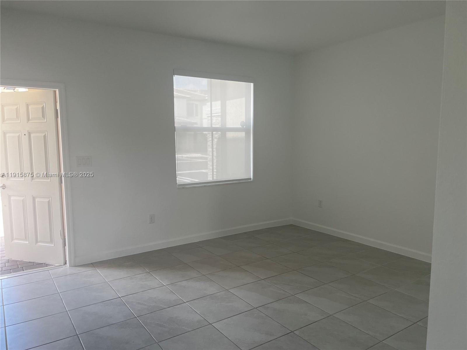 28701 Southwest 132nd Place Homestead, FL 33033 - Photo 5 of 17 an empty room with windows