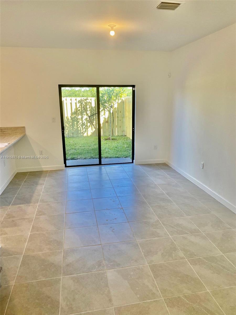 28701 Southwest 132nd Place Homestead, FL 33033 - Photo 6 of 17 a view of an empty room with a window