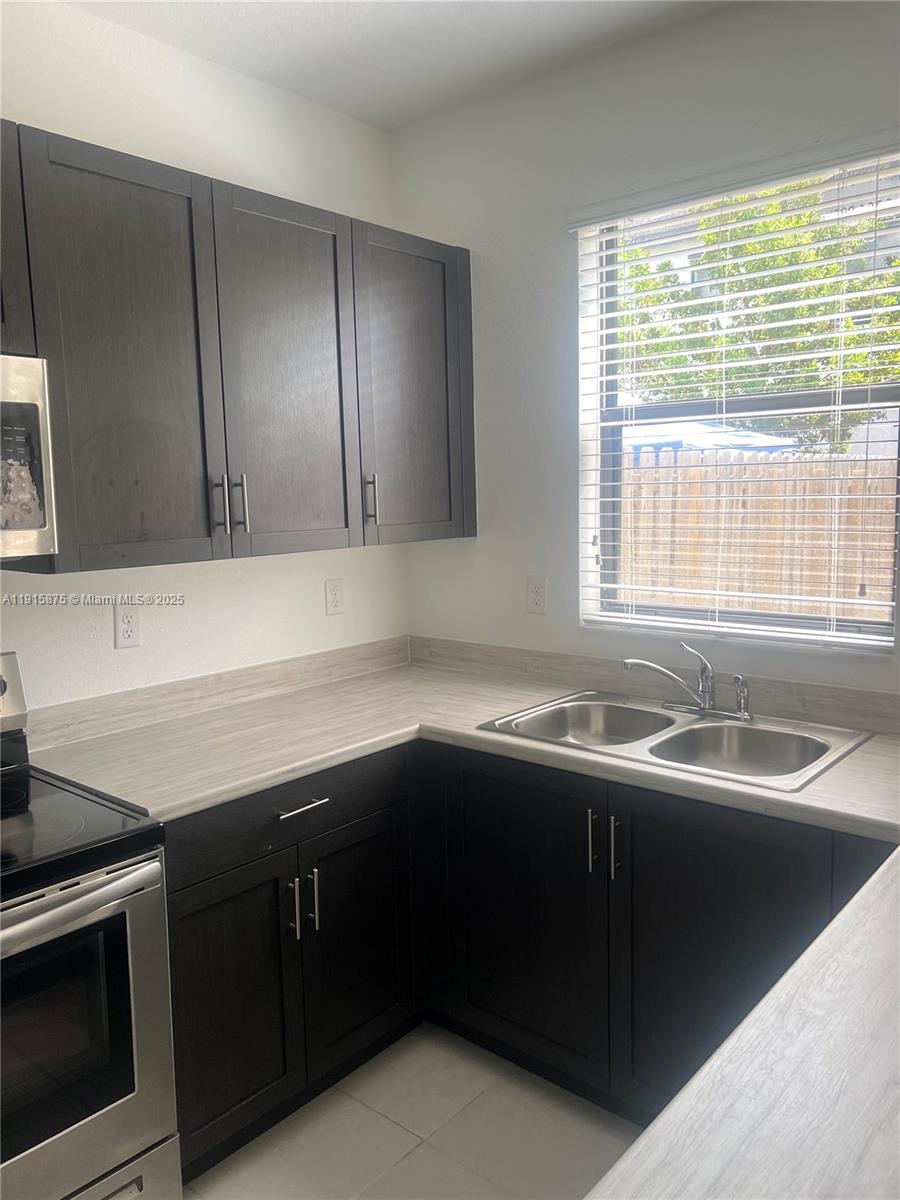 28701 Southwest 132nd Place Homestead, FL 33033 - Photo 8 of 17 a kitchen with a sink and a stove