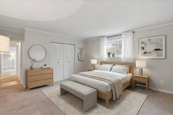 a bedroom with a bed mirror and a window