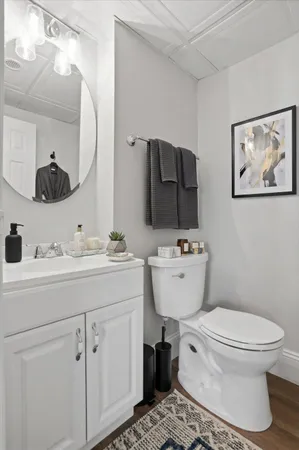 a bathroom with a toilet sink and mirror