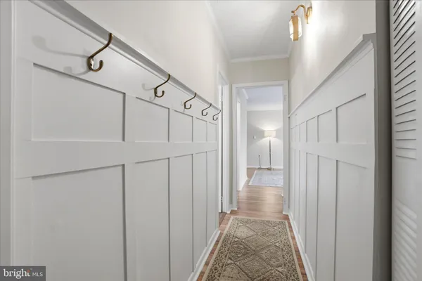 a view of a hallway with white walls and stairs
