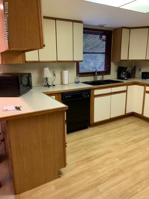 1226 Kroucher Road Stroudsburg, PA 18360 - Photo 13 of 28 a kitchen with stainless steel appliances a sink a stove a refrigerator cabinets and a counter top space