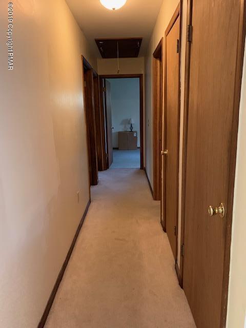1226 Kroucher Road Stroudsburg, PA 18360 - Photo 16 of 28 a view of a hallway with wooden shelves
