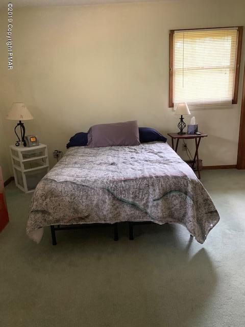1226 Kroucher Road Stroudsburg, PA 18360 - Photo 17 of 28 a bedroom with a bed and window