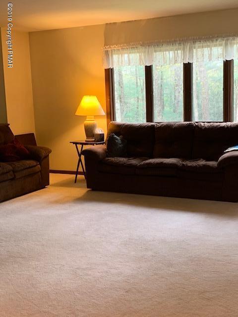 1226 Kroucher Road Stroudsburg, PA 18360 - Photo 8 of 28 a living room with furniture and large windows
