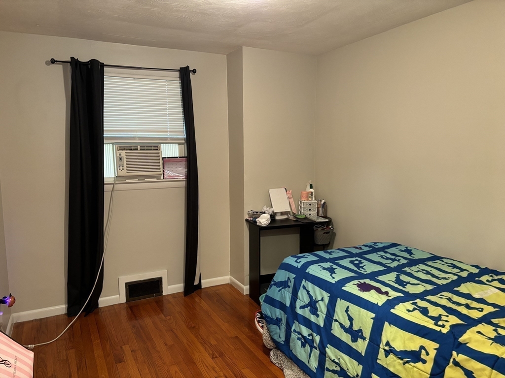 81 Brickett Street Springfield, MA 01119 - Photo 10 of 18 a bedroom with a bed and a table in it