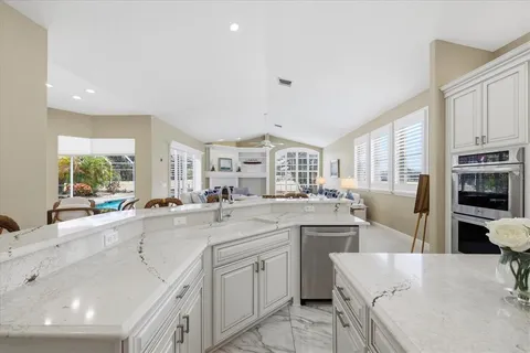 a kitchen with counter top space sink stove and cabinets