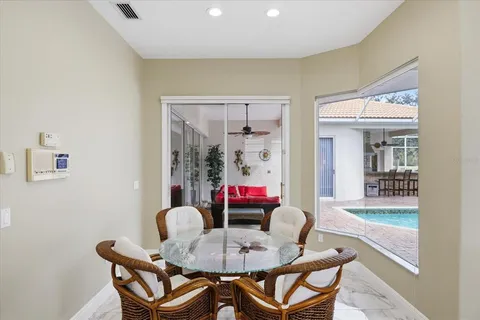 a dining room with furniture and glass door