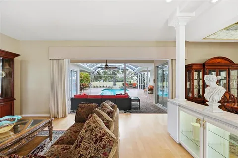 a living room with a large window and furniture