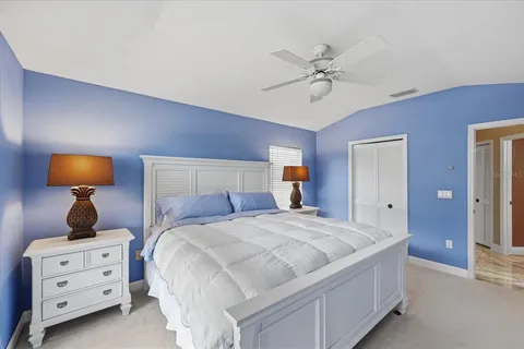 a spacious bedroom with a bed and a window