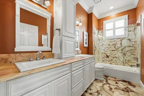 a bedroom with furniture and a rug