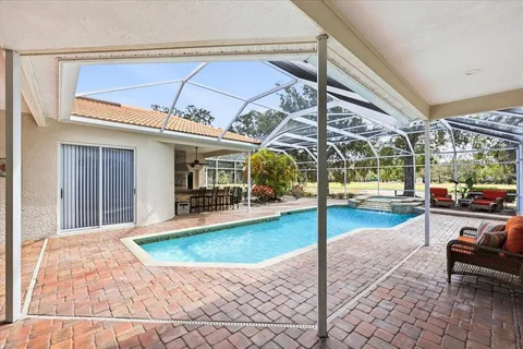 a swimming pool with outdoor seating and yard