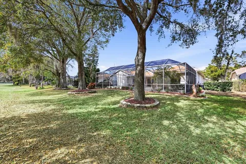 an aerial view of a house with a garden and lake view