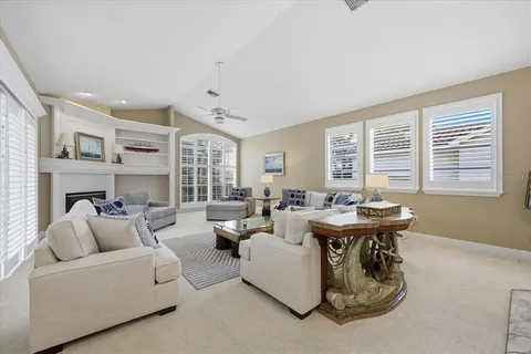 a living room with fireplace furniture and a window