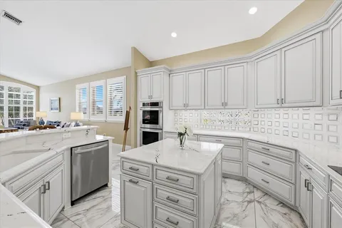 a kitchen with cabinets appliances and a counter space