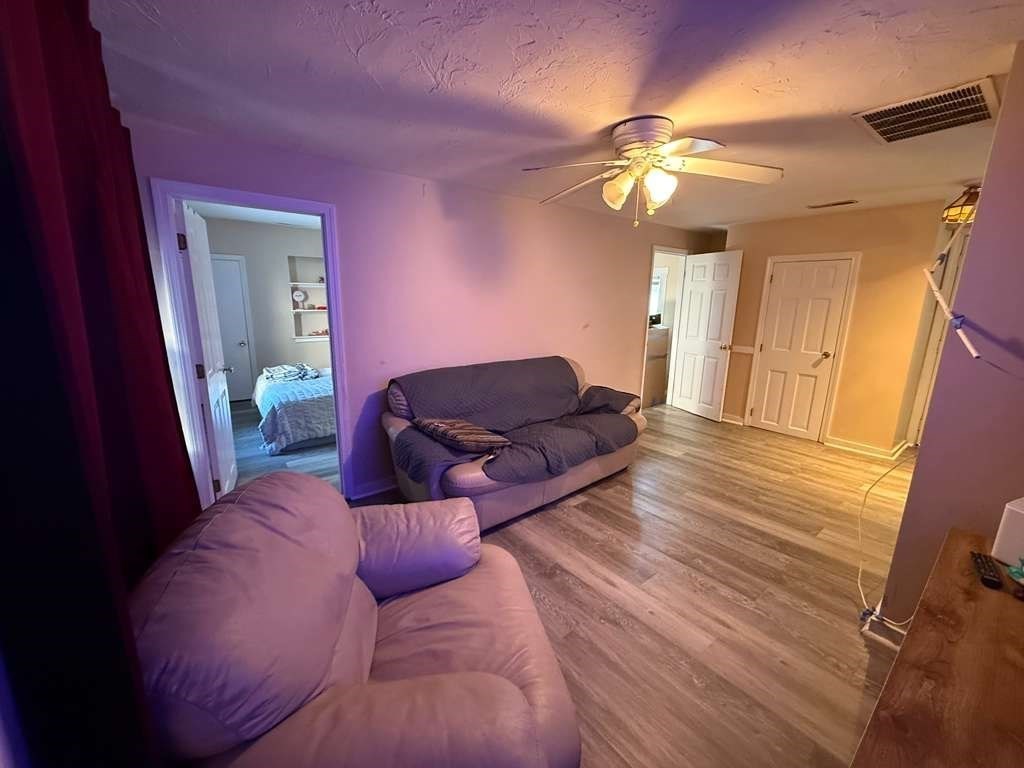 98 School Street Lowell, MA 01854 - Photo 14 of 40 a living room with furniture a chandelier and a window