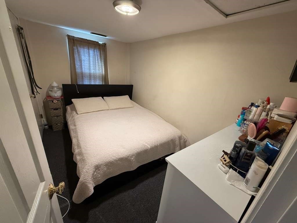 98 School Street Lowell, MA 01854 - Photo 16 of 40 a bedroom with a bed and a dresser