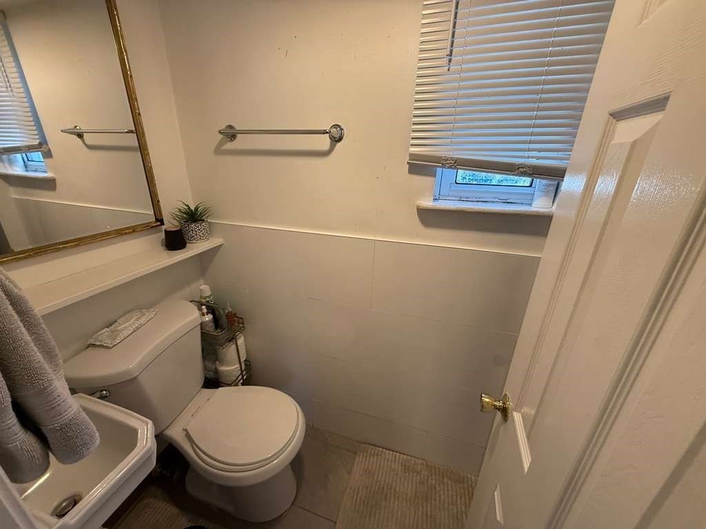 98 School Street Lowell, MA 01854 - Photo 17 of 40 a bathroom with a toilet and a sink