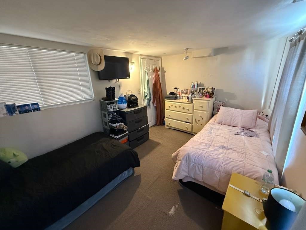 98 School Street Lowell, MA 01854 - Photo 19 of 40 a bedroom with bed and window