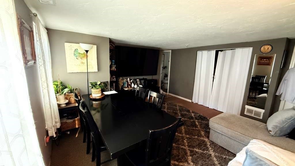 98 School Street Lowell, MA 01854 - Photo 21 of 40 a view of a dining room with furniture and a window