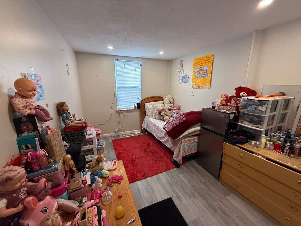 98 School Street Lowell, MA 01854 - Photo 25 of 40 a living room with furniture and a wooden floor