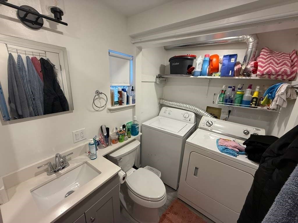 98 School Street Lowell, MA 01854 - Photo 26 of 40 a bathroom with a sink and a toilet